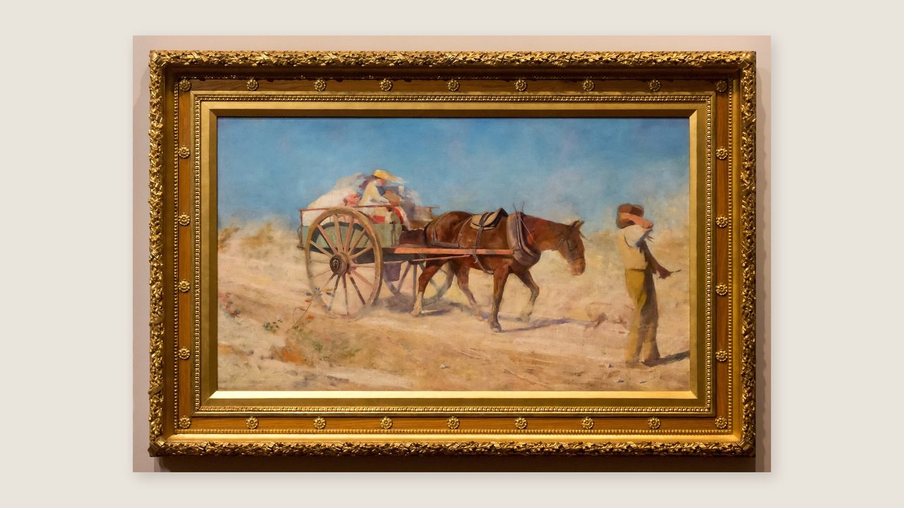 Frederick McCubbin's painting The North Wind, a horse and cart in a dusty landscape, in a gilt frame on a soft grey wall